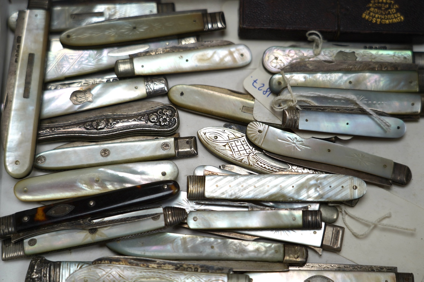 A collection of twenty two assorted mainly Victorian mother of handled silver fruit knives, one with leather case, together with a similar sterling knife and four Georgian silver travelling forks, three with mother of pe